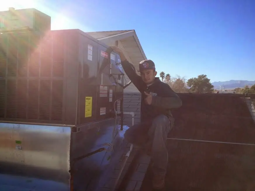 HVAC technician performing Boiler Repair on a rooftop unit in South Fulton